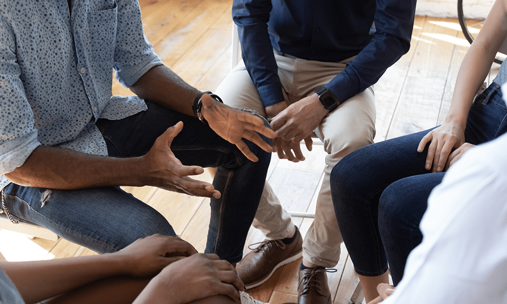 images showing group sitting with hands in their lap