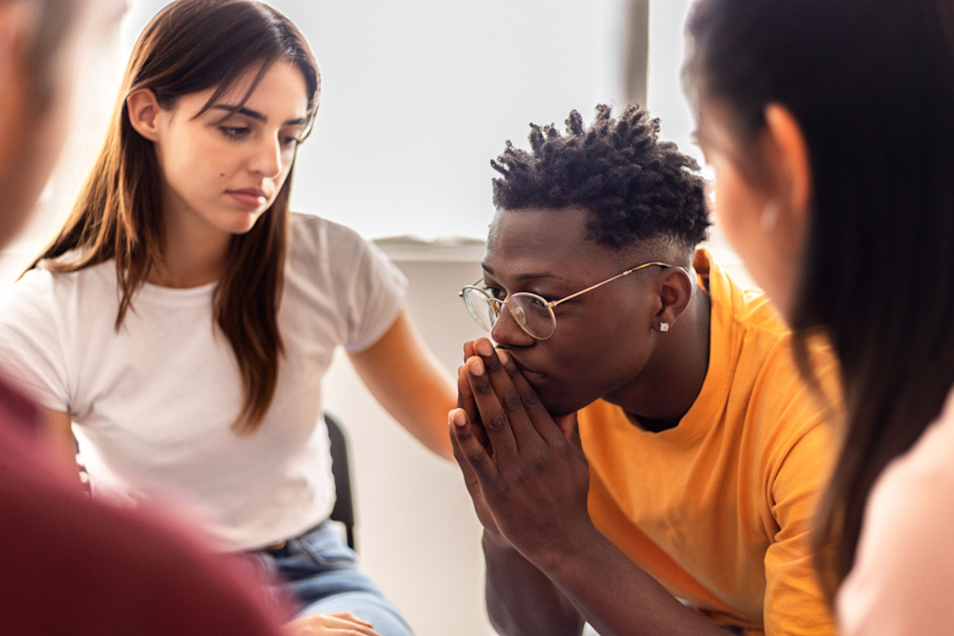 man sitting in front of group for addiction therapy
